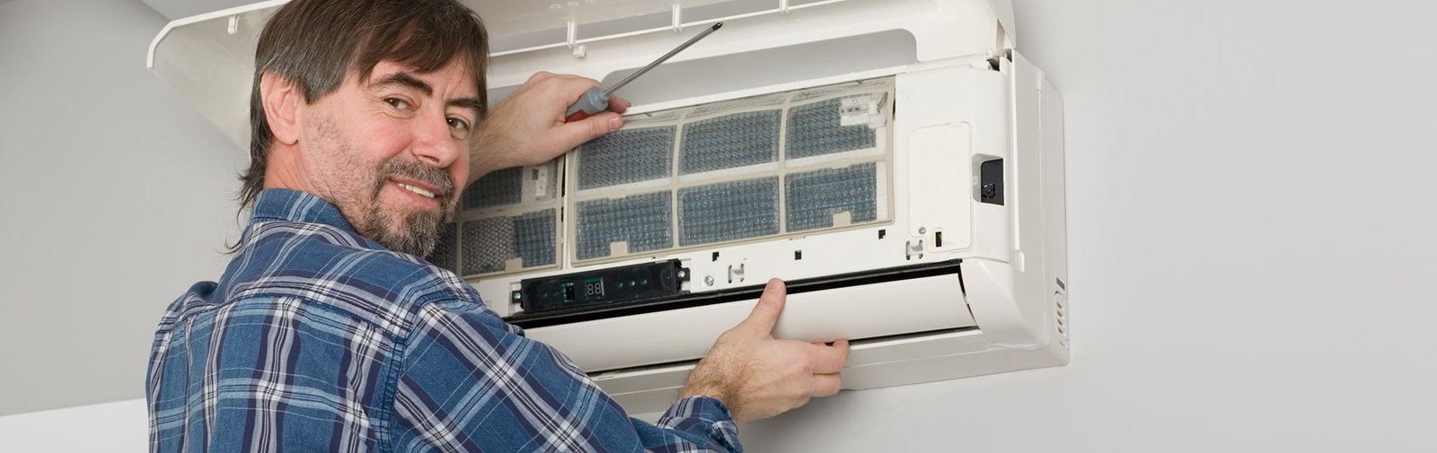 Technician repairing an air conditioning unit, step-by-step process
